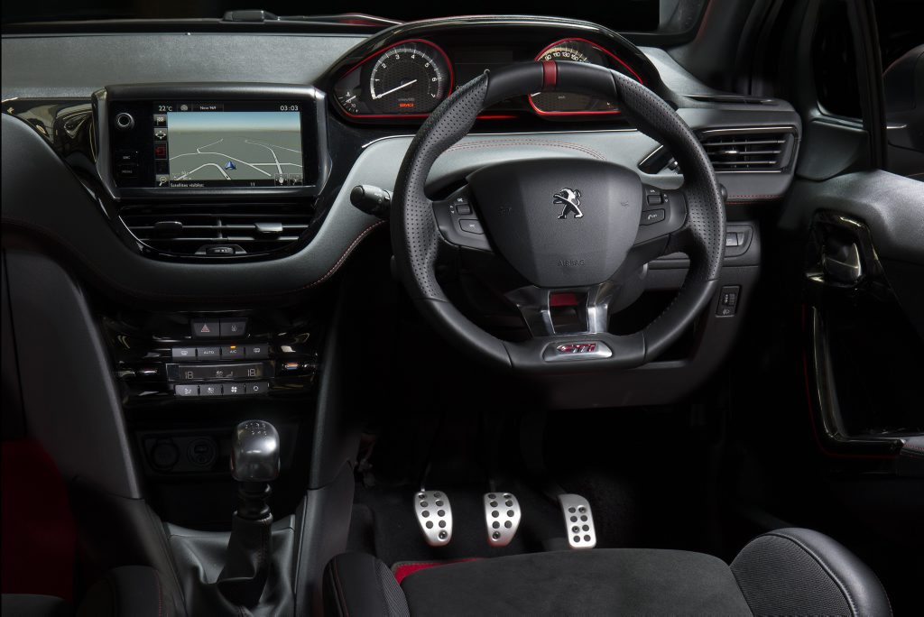 RACE READY: 30th's cabin has abundance of red for the trim, stitching, steering wheel and floor mats. Note the high instrument cluster so it remains in peripheral vision. RACE READY: 30th's cabin has abundance of red for the trim, stitching, steering wheel and floor mats. Note the high instrument cluster so it remains in peripheral vision.